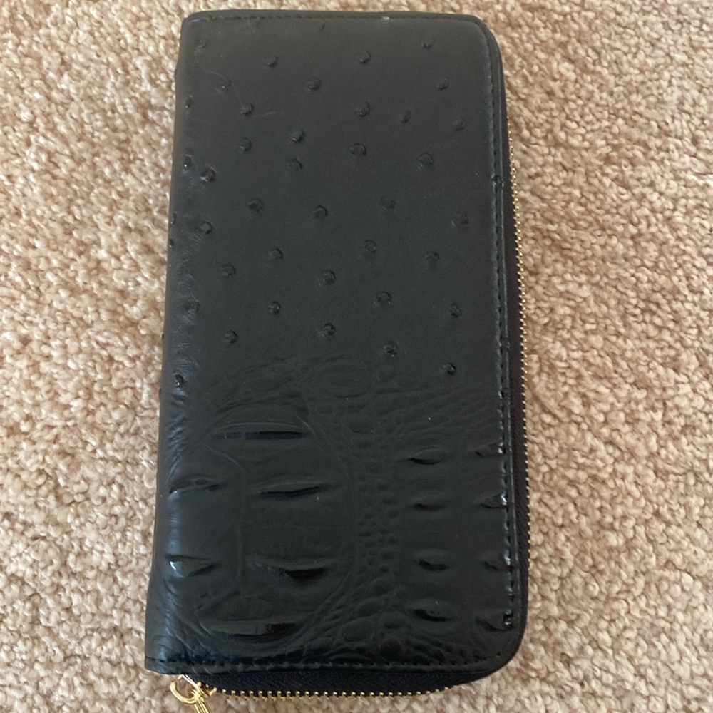 Black wallet with gold zipper.